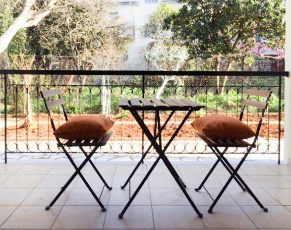 two chairs and a table in front of a window at Spell's in Corfu