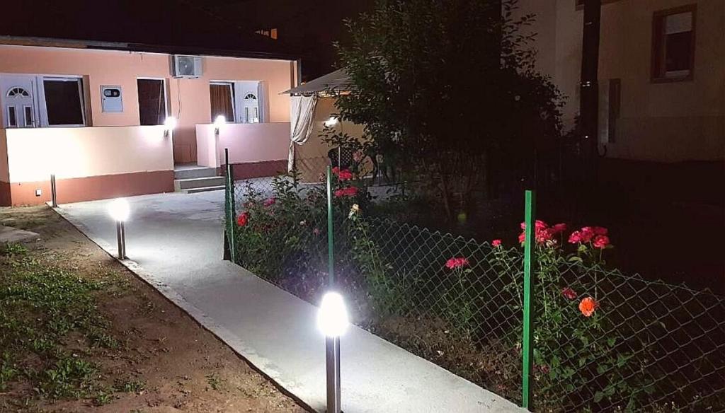 a fence with lights in front of a house at night at Studio Isakovic Centar in Soko Banja