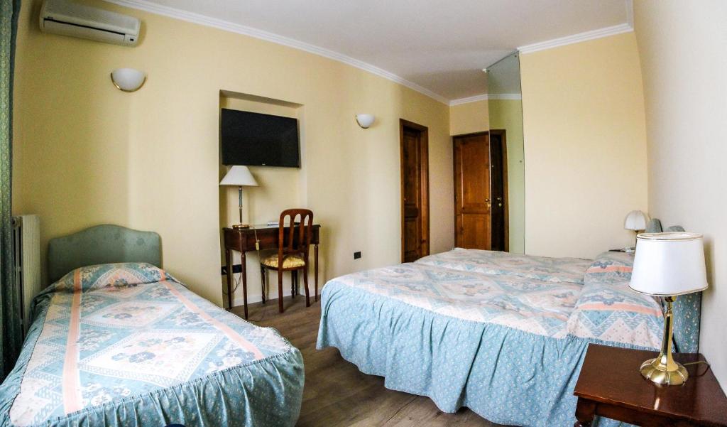Postel nebo postele na pokoji v ubytování Hotel Moderno