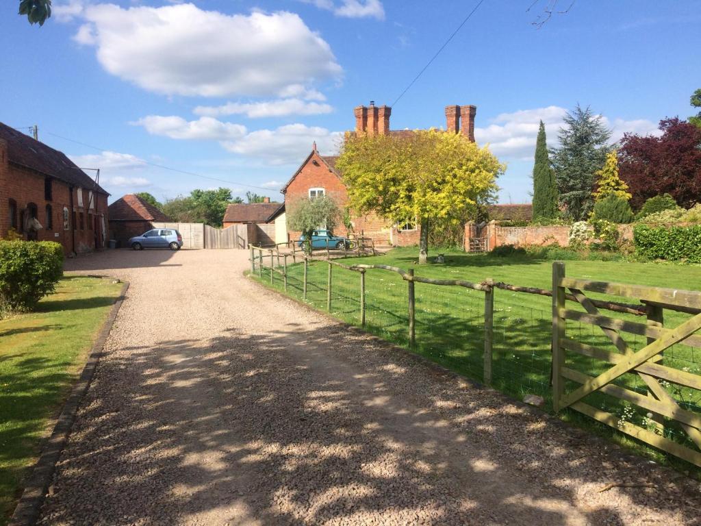 a road leading to a house with a fence at Gilberts End Farm in Great Malvern