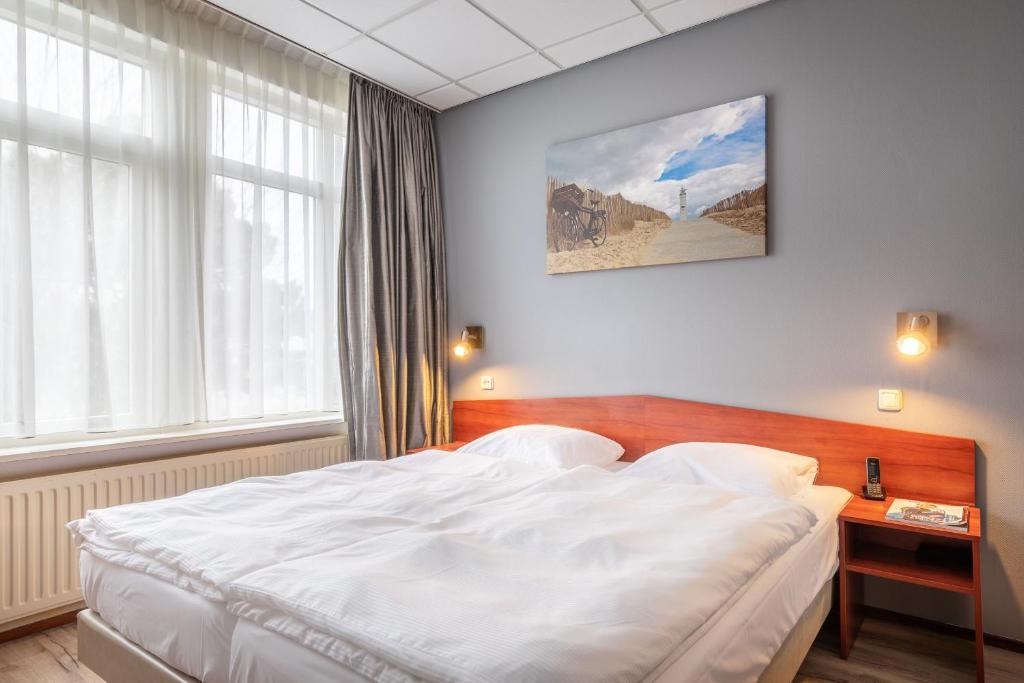 Postel nebo postele na pokoji v ubytování Two Brothers Hotel Astoria