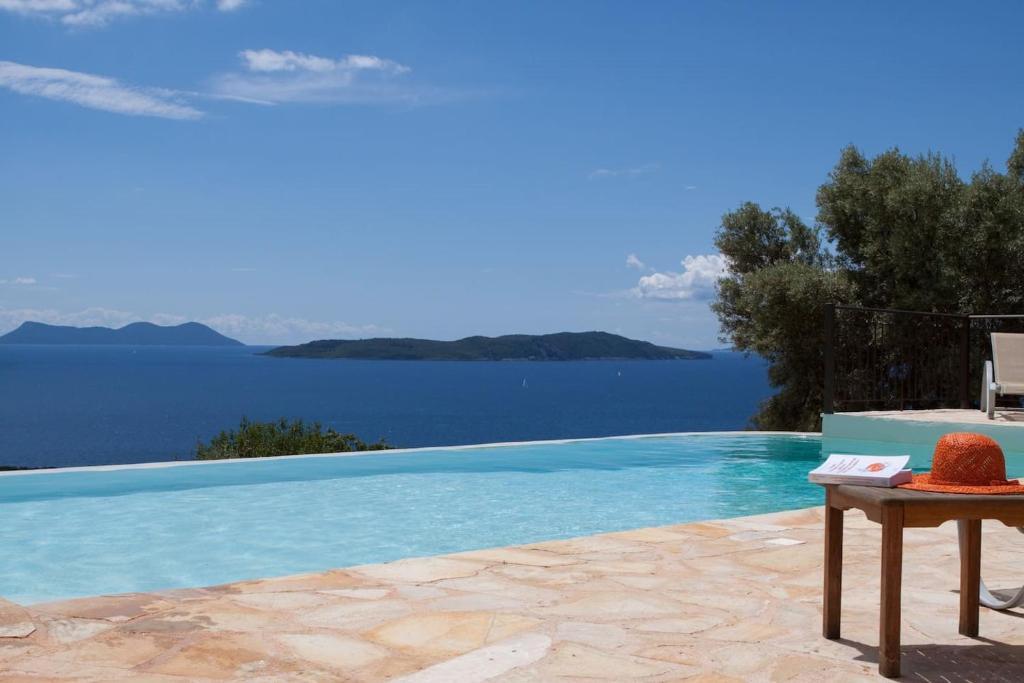 a swimming pool with a view of the water at Villa Boubouki in Évyiros