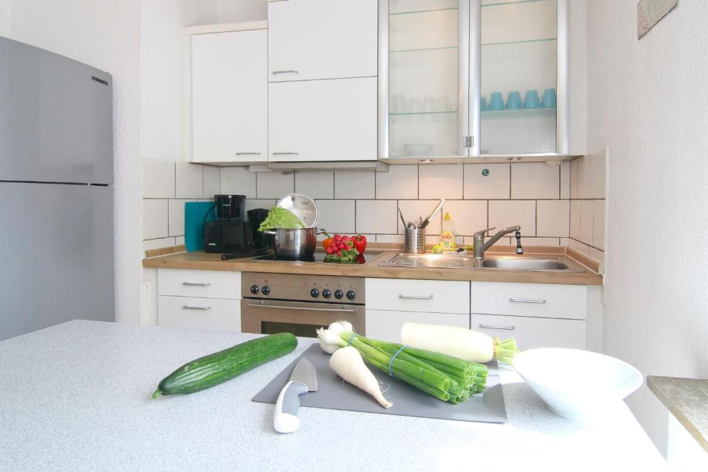 a kitchen counter with vegetables on a cutting board at apartmondo Ferienwohnungen Wuppertal in Wuppertal