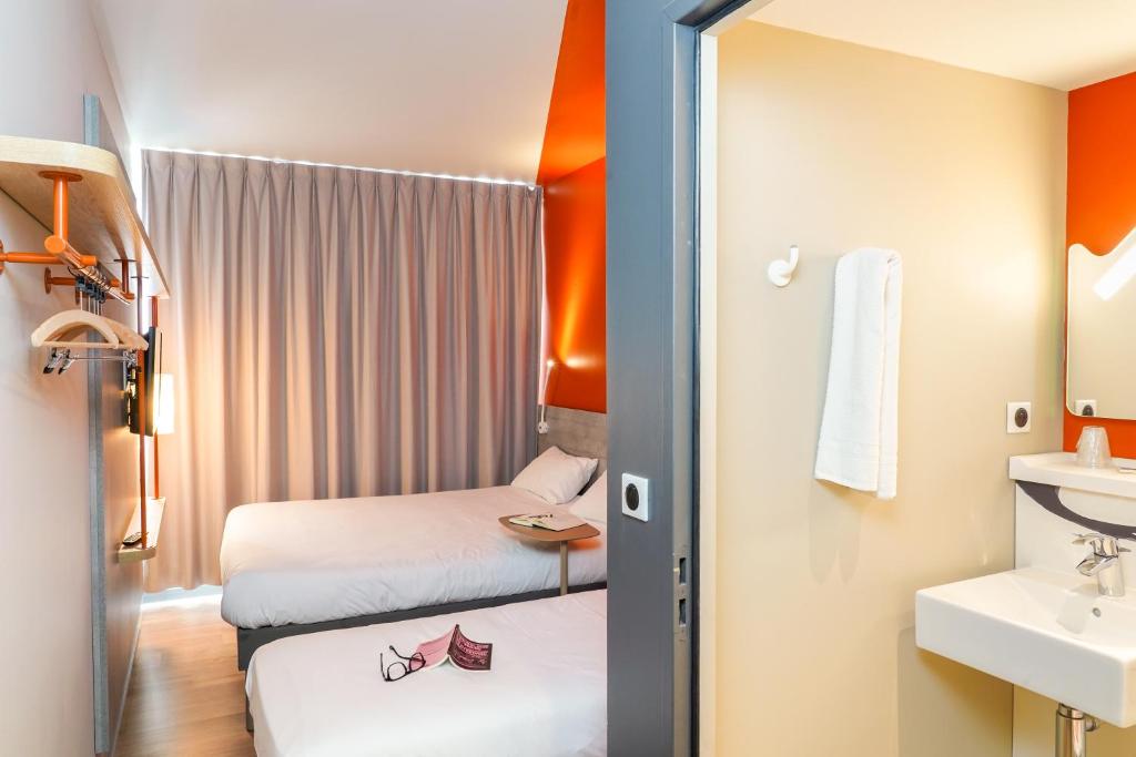 Postel nebo postele na pokoji v ubytování Ibis Budget Aubenas