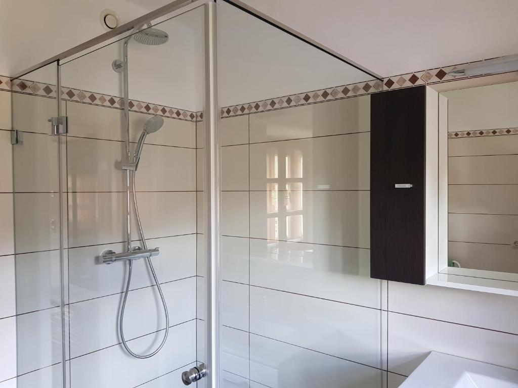 a shower with a glass door in a bathroom at Ferienappartement am Leisnitzbach in Tamsweg