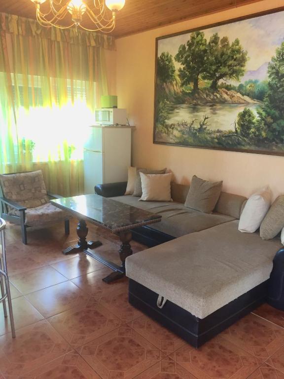 a living room with a couch and a table at Big Apartman in Hajdúszoboszló