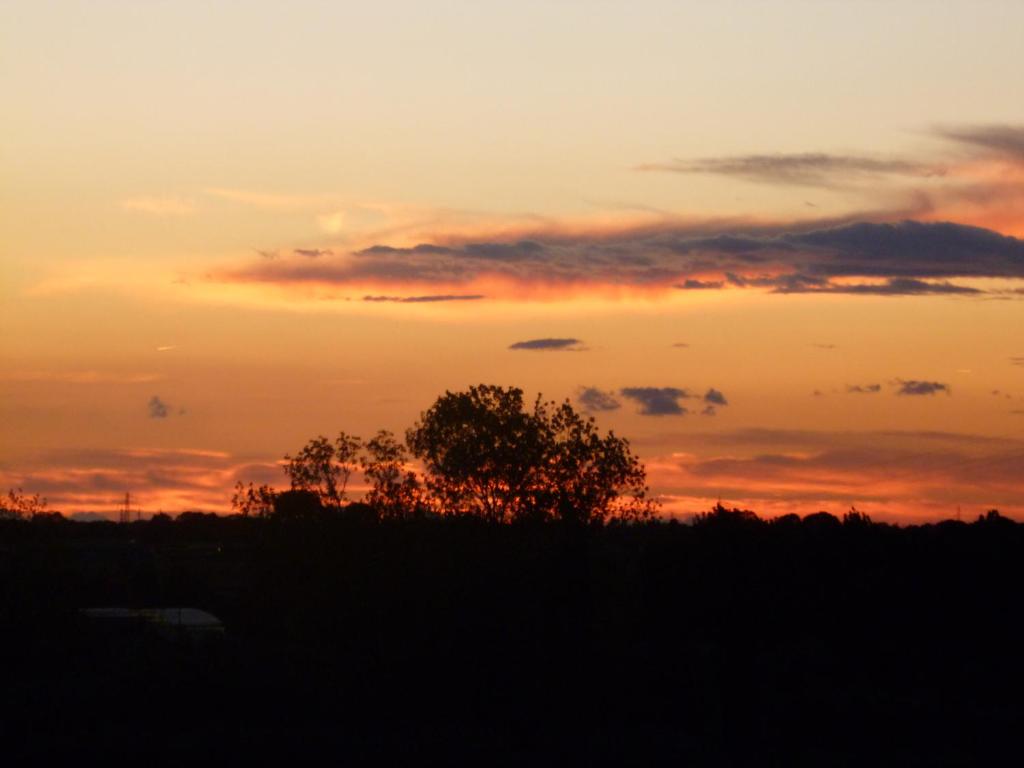 The sunrise or sunset as seen from a panziókat or nearby