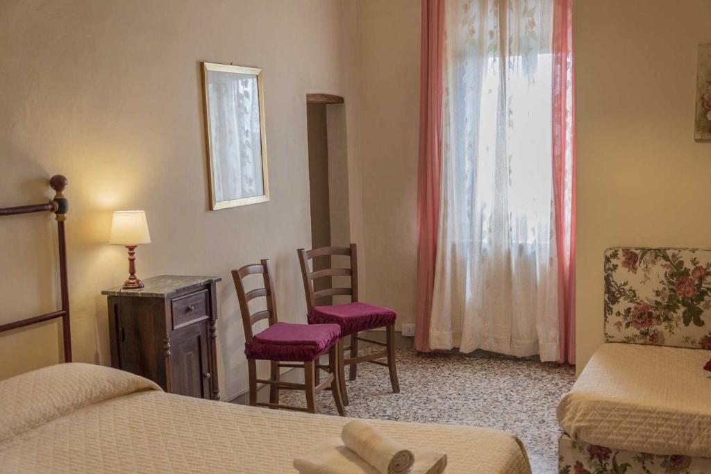 Postel nebo postele na pokoji v ubytování Agriturismo La Ripolina