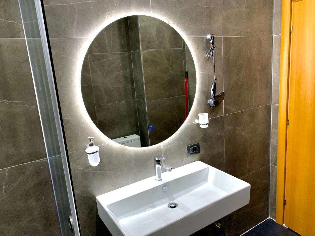 a bathroom with a sink and a mirror at EKA Luxury Two-Bedroom Premium Apartment 2 in Durrës