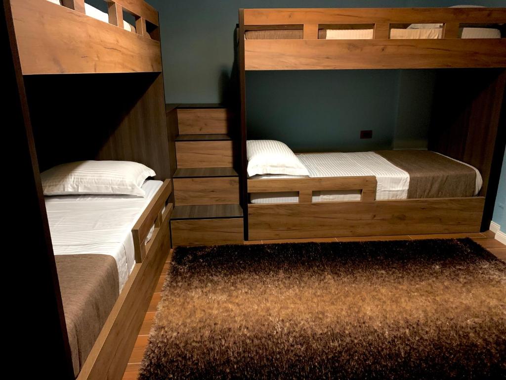 two bunk beds are in a room withthritisthritisthritisthritisthritisthritisthritisthritis at EKA Luxury Two-Bedroom Premium Apartment 2 in Durrës