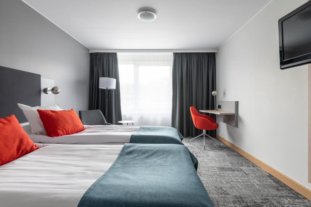 Postel nebo postele na pokoji v ubytování Quality Hotel Prisma