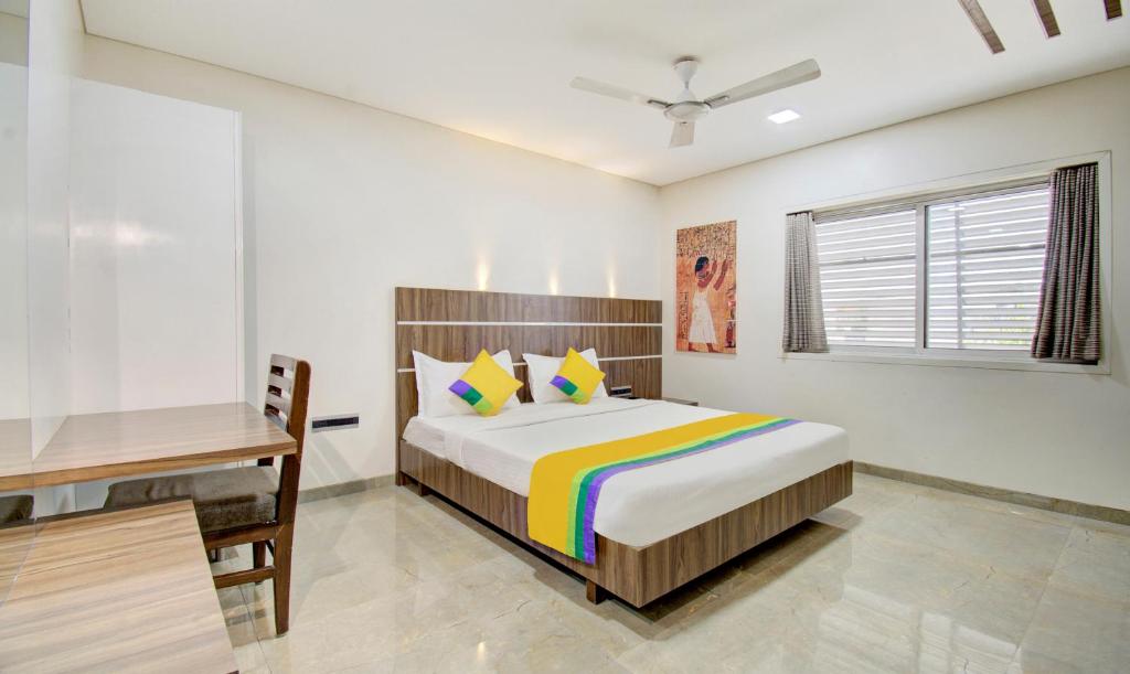 1 dormitorio con cama y escritorio. en Treebo Trend Lalaji's Executive, en Aurangabad