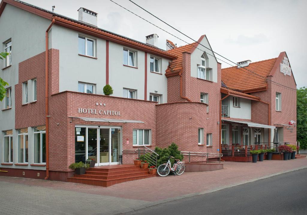 a building with two bikes parked in front of it at Hotel Capitol in Biała Podlaska