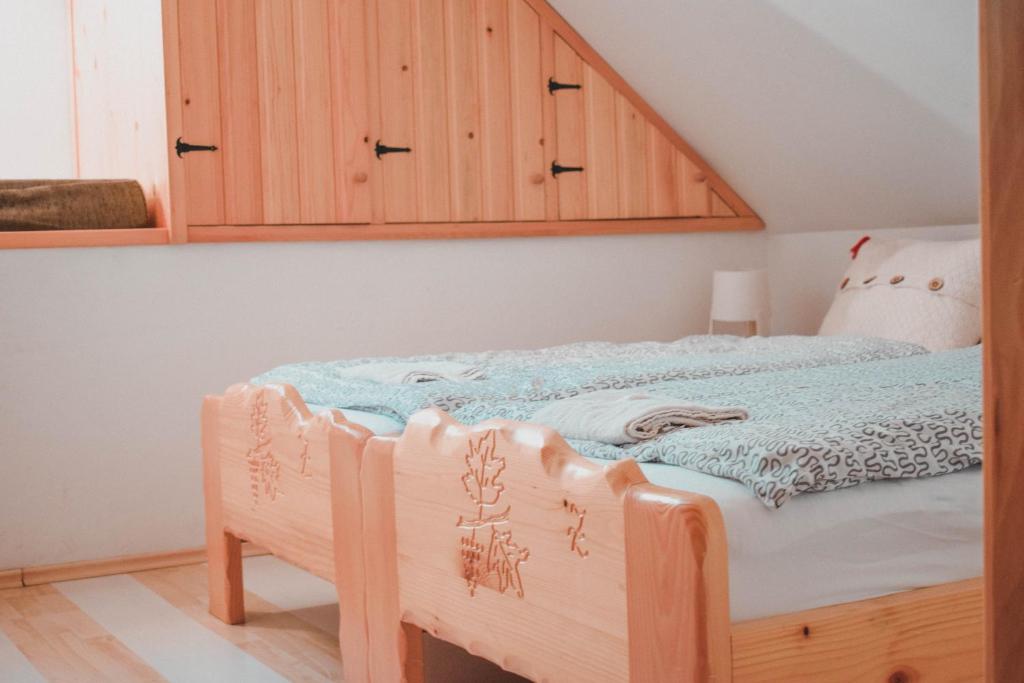 a bedroom with a bed with a wooden cabinet at Vinska kuća na vinskoj cesti Zmajevac in Zmajevac