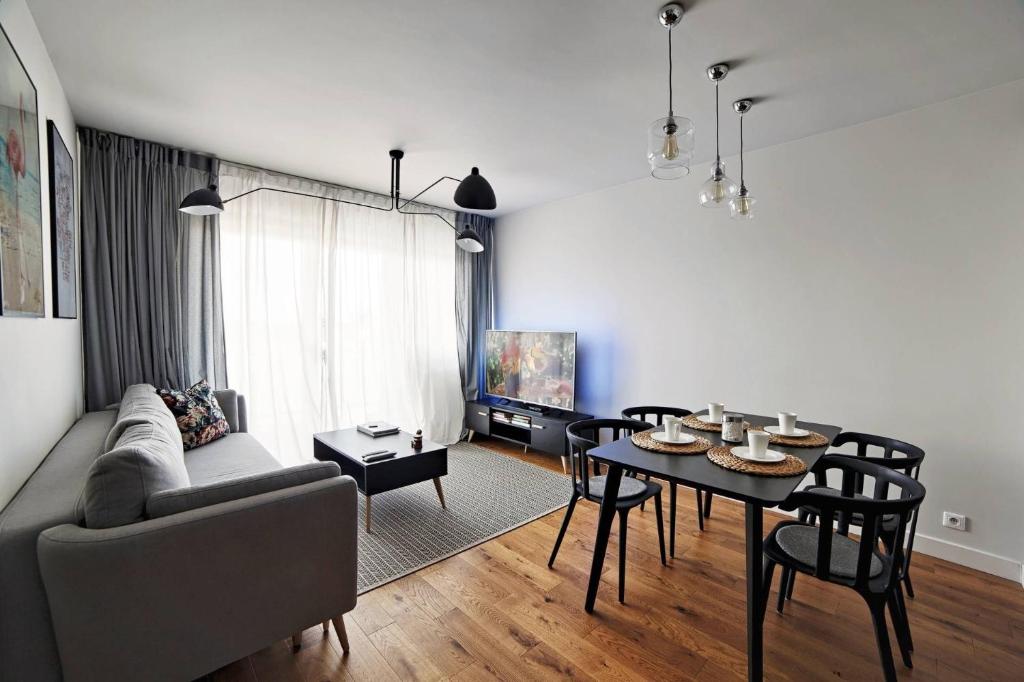 un soggiorno con divano e tavolo di One Apartment a Śrem