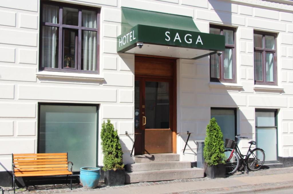 a building with a bench in front of a building at Go Hotel Saga in Copenhagen