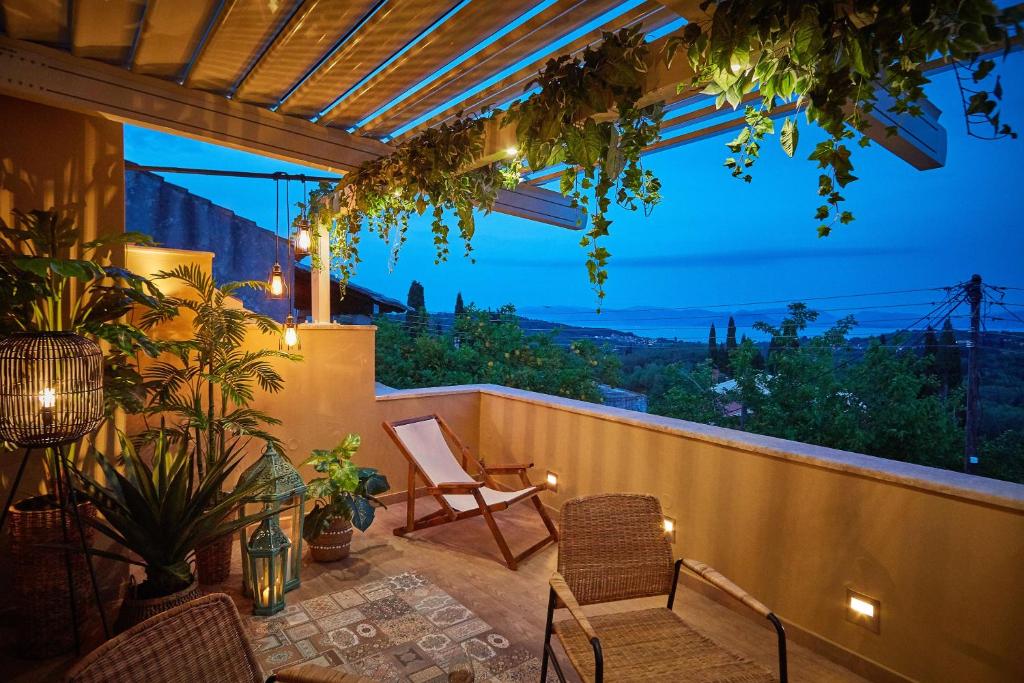 a patio with a view of the mountains at night at Lianelia LUXURY Village House in Argyrádes