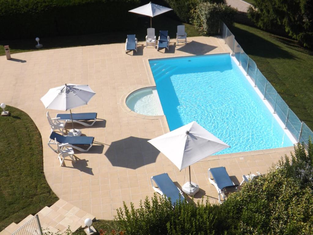 an overhead view of a swimming pool with umbrellas and chairs at  