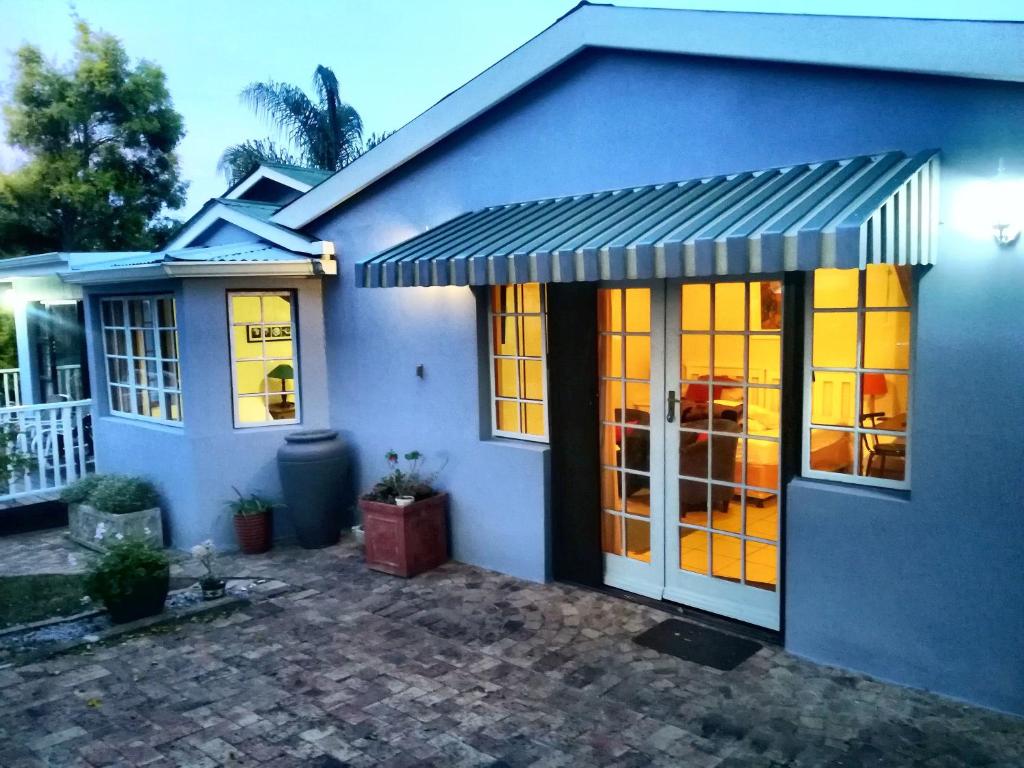 a blue house with awning on it at Antique Silk Self Catering Unit in Grahamstown