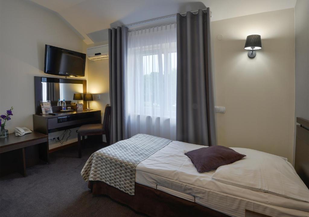 Posteľ alebo postele v izbe v ubytovaní Hotel Capitol