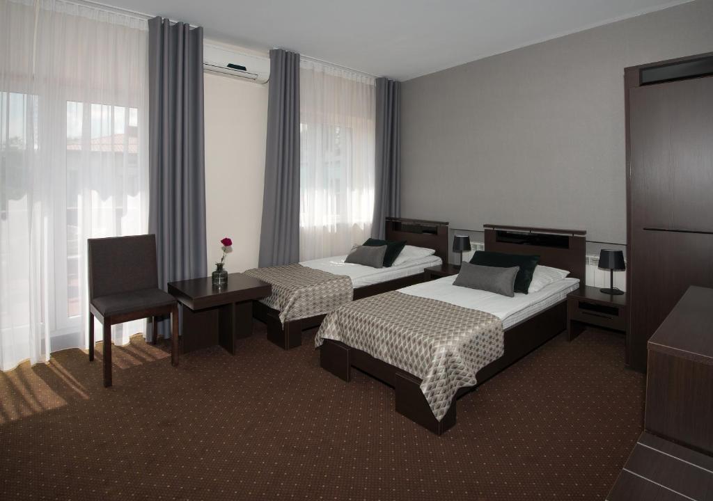 Posteľ alebo postele v izbe v ubytovaní Hotel Capitol