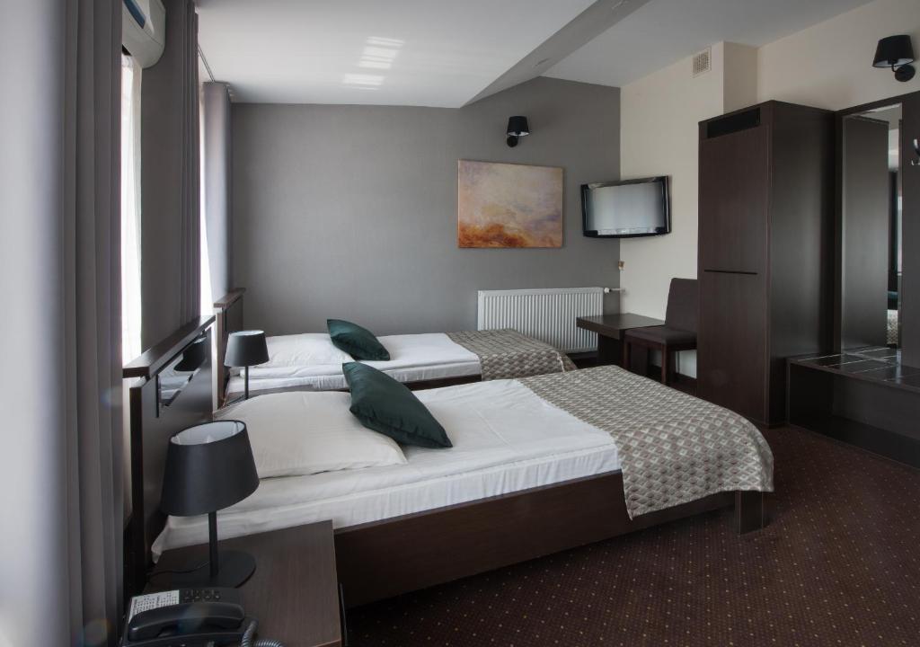 Posteľ alebo postele v izbe v ubytovaní Hotel Capitol