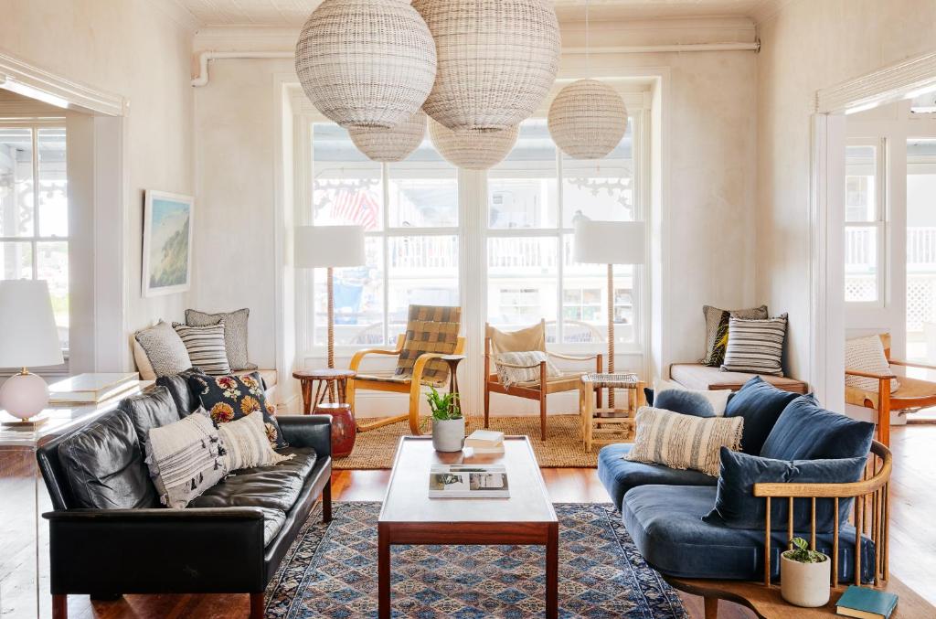 a living room with couches and a table at Block Island Beach House in New Shoreham