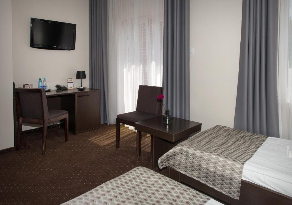 Posteľ alebo postele v izbe v ubytovaní Hotel Capitol