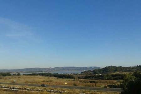 a view of a field with the ocean in the background at Appartement Narbonne in Narbonne