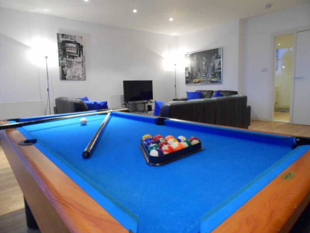 a pool table in a living room with a bill at Modern 2-bedroom Apt near SSE Hydro and SEC in Glasgow