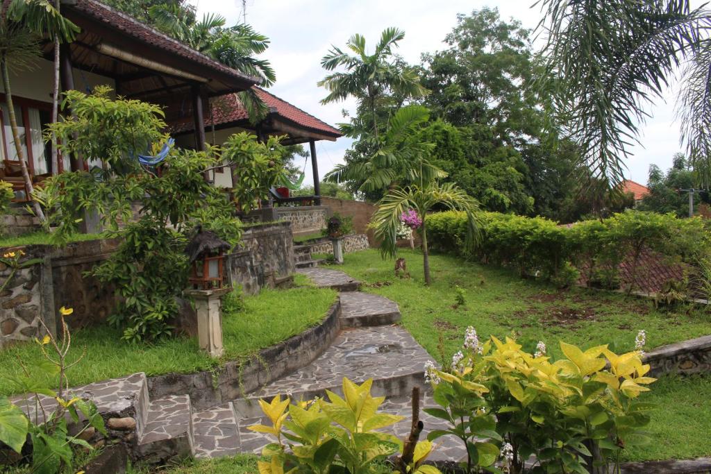 a garden in front of a house at Bamboo Bali in Amed