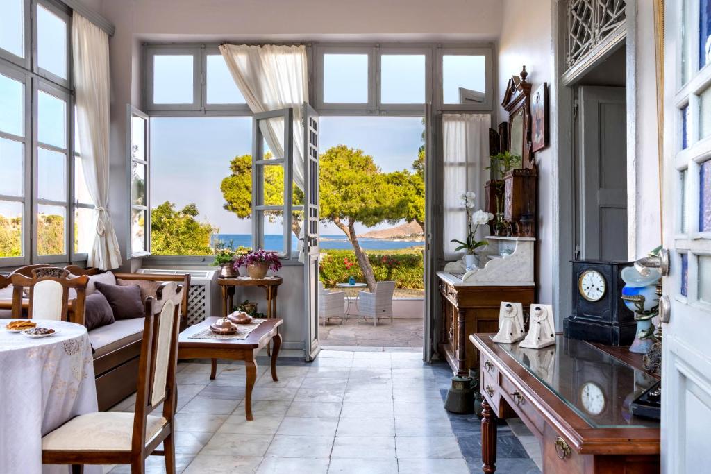 a living room with a view of the ocean at DellaGracia Mansion in Poseidonia Syros in Posidhonía