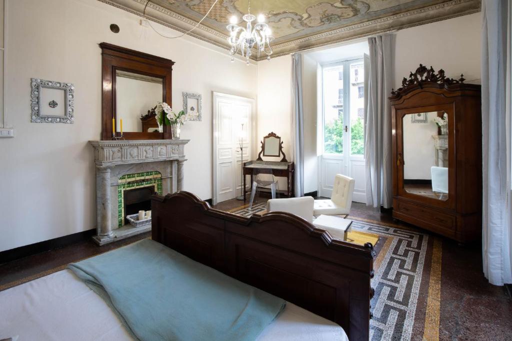 a living room with a bed and a fireplace at Corso Mazzini in Savona