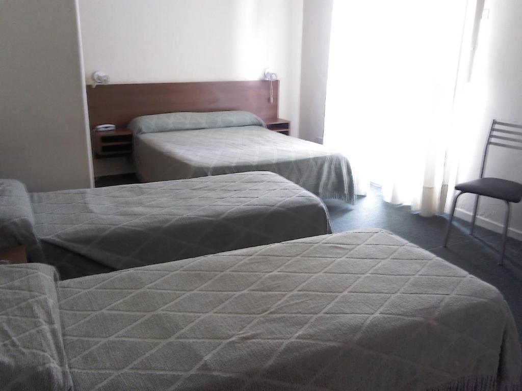 a bedroom with two beds and a window at Real Splendid Hotel in Buenos Aires