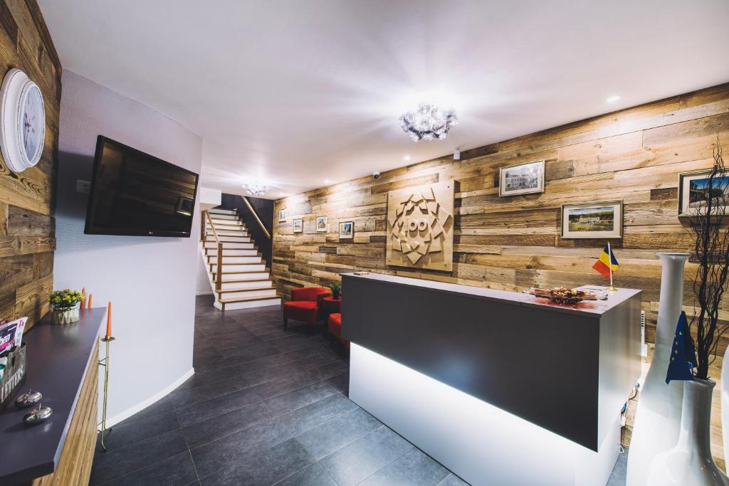 a lobby with wooden walls and a reception desk at Derby AH in Alba Iulia