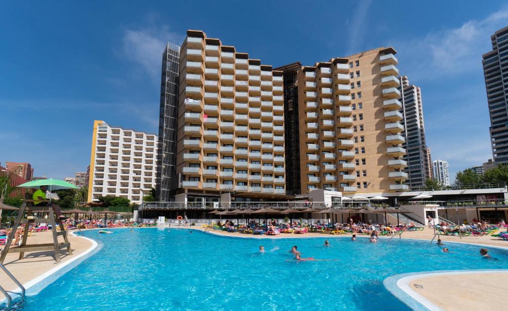 a large swimming pool with people in a hotel at Medplaya Hotel Rio Park in Benidorm