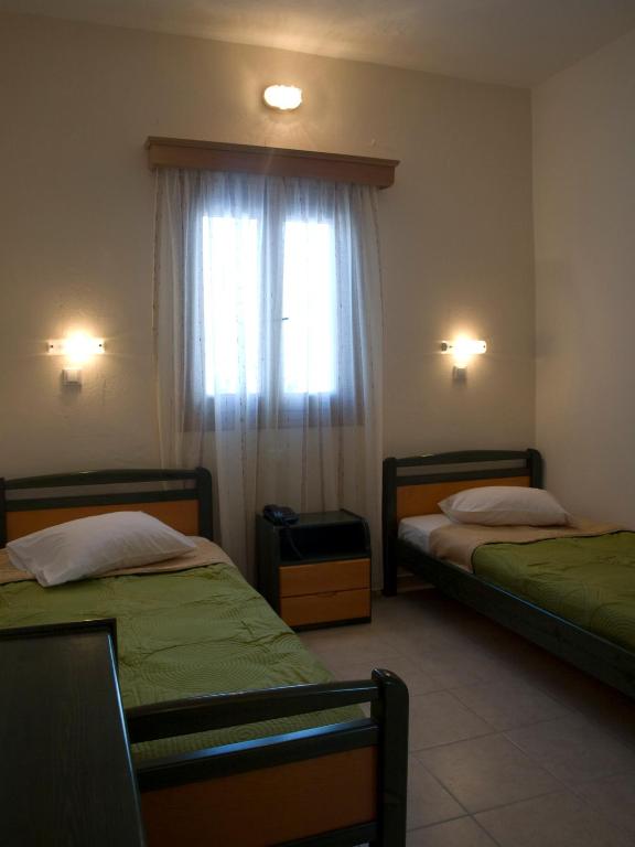 Postel nebo postele na pokoji v ubytování Galaxy Hotel