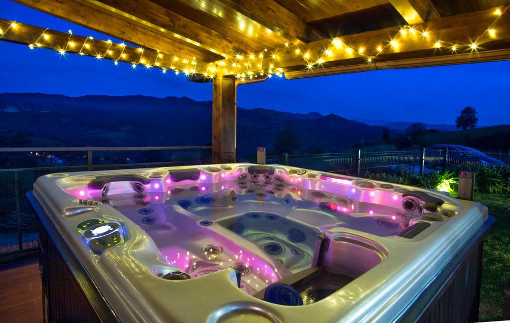 a jacuzzi tub sitting on a deck with lights at Oviedo Real Spa in Oviedo