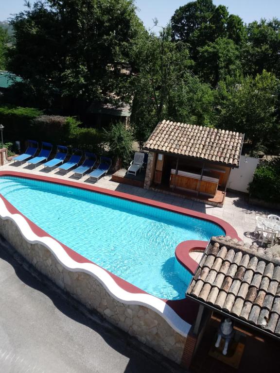 a swimming pool with lounge chairs and a house at Parco Sogni d'Oro in Montella