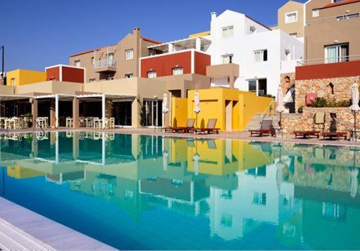 a swimming pool in front of a building at Apolis Beachscape Hotel in Amoopi