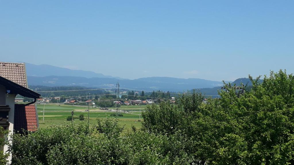 a view of a field with trees and a building at Haus Sonja in Faak am See