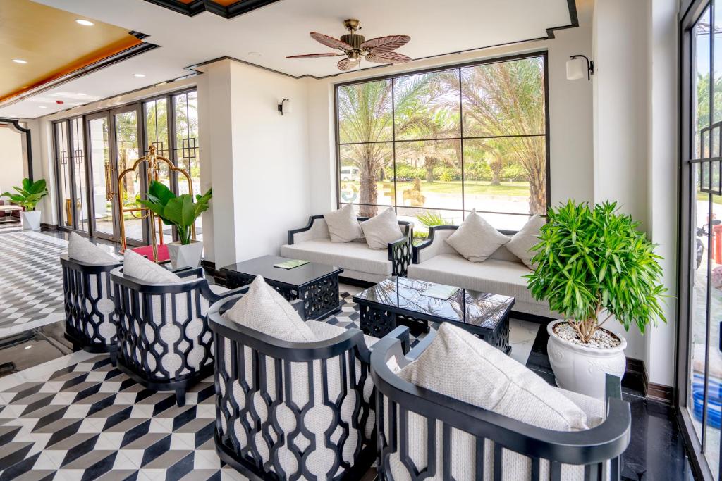 a living room with black and white checkered floor at Fivitel Hoi An Hotel in Hoi An