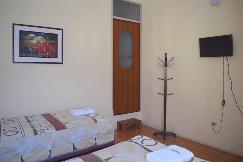 Postel nebo postele na pokoji v ubytování Mango Hostel B&B