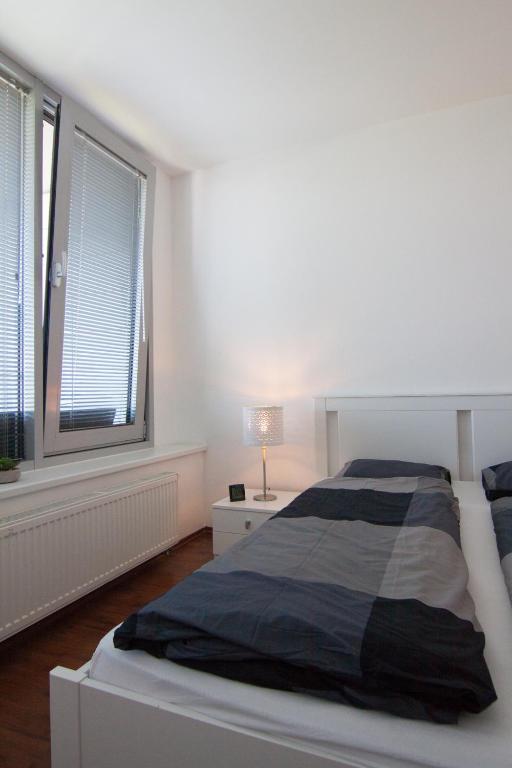 A bed or beds in a room at Juls Apartment next to football and hockey stadium