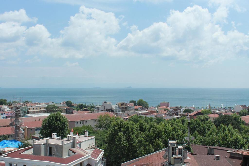 a view of a city with the ocean in the background at Good Night Hotel Istanbul in Istanbul