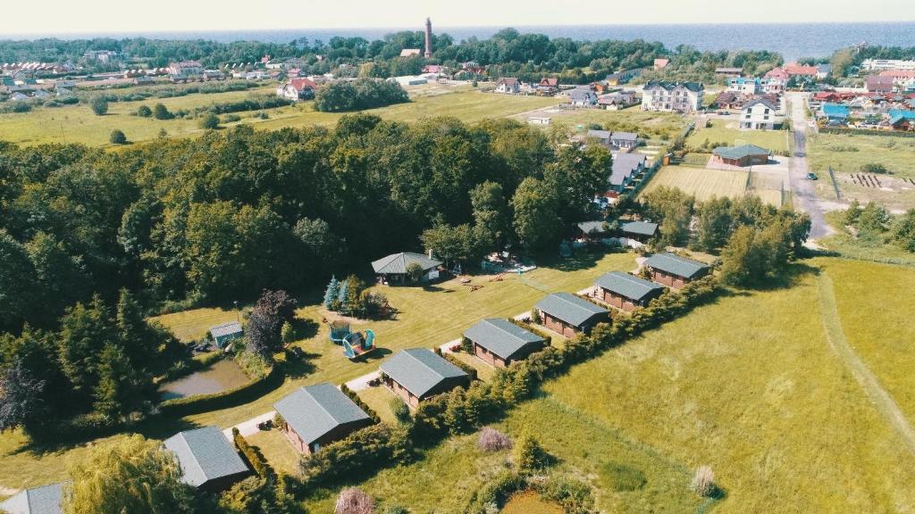 an aerial view of a village with houses and trees at Koło Żółwia in Gąski