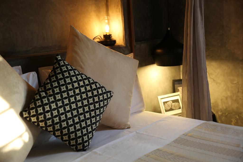 Postel nebo postele na pokoji v ubytování Joya' Beach Suites & Villa