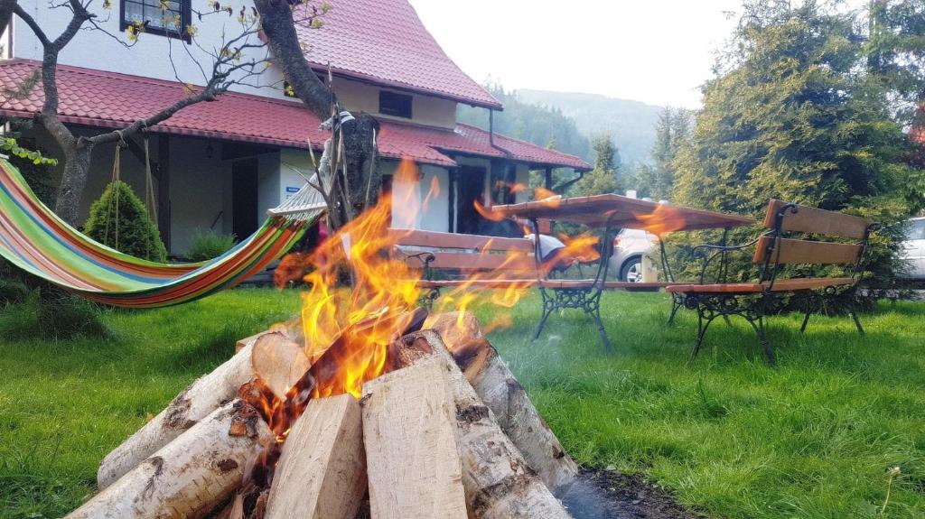 a fire pit with flames in front of a house at Willa pod Jemiołą in Wisła