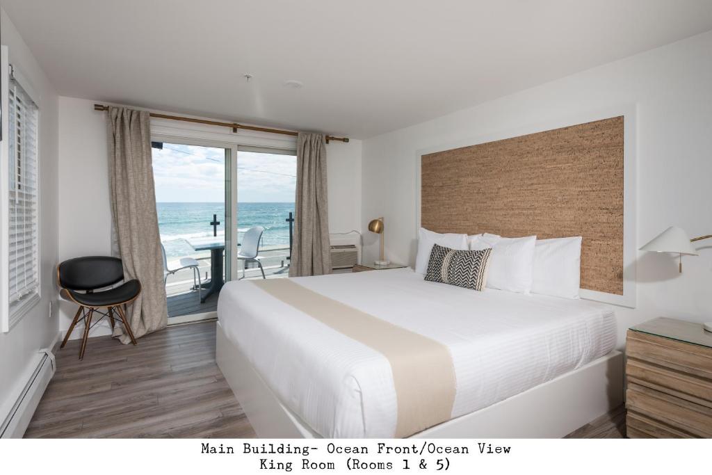 a bedroom with a bed and a view of the ocean at Stones Throw in York Beach