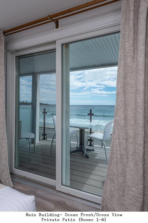 a room with a window looking out at the ocean at Stones Throw in York Beach
